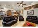 Living room with dark leather furniture and kitchen views at 5701 N 105Th Ln, Glendale, AZ 85307