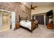 Main bedroom with a unique antler headboard and a stone accent wall at 5701 N 105Th Ln, Glendale, AZ 85307
