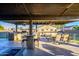 Covered patio with outdoor kitchen, dining area, and fire pit at 5701 N 105Th Ln, Glendale, AZ 85307