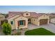 Single-story home with a two-car garage, artificial turf, and desert landscaping at 7369 W Cactus Wren Way, Florence, AZ 85132