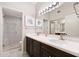 Bathroom boasts double vanity, marble countertops, and a glass shower at 7710 E Gainey Ranch Rd # 157, Scottsdale, AZ 85258