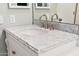 Bathroom vanity with a single sink and marble countertop at 7710 E Gainey Ranch Rd # 157, Scottsdale, AZ 85258