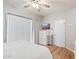 Bright bedroom with wood floors, sliding door, and ample closet space at 7710 E Gainey Ranch Rd # 157, Scottsdale, AZ 85258