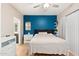 Bedroom with a queen bed and blue accent wall at 7710 E Gainey Ranch Rd # 157, Scottsdale, AZ 85258