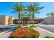 Community clubhouse entrance with palm trees and landscaping at 7710 E Gainey Ranch Rd # 157, Scottsdale, AZ 85258
