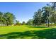 Open green space with mature trees and grassy areas at 7710 E Gainey Ranch Rd # 157, Scottsdale, AZ 85258