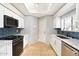 Modern kitchen with white cabinets, granite counters, and stainless steel appliances at 7710 E Gainey Ranch Rd # 157, Scottsdale, AZ 85258