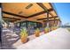 Community outdoor lounge area with tables, chairs, and potted plants at 7710 E Gainey Ranch Rd # 157, Scottsdale, AZ 85258