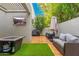 Relaxing patio with artificial turf, fire pit, and outdoor TV at 7710 E Gainey Ranch Rd # 157, Scottsdale, AZ 85258