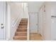 Light-filled staircase with wood-look flooring and neutral walls at 7710 E Gainey Ranch Rd # 157, Scottsdale, AZ 85258
