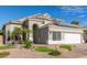 Two-story house with solar panels, landscaped yard, and a brick pathway at 13014 W Dreyfus Dr, El Mirage, AZ 85335