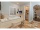 Relaxing bathroom with a luxurious soaking tub and access to a walk-in closet at 1409 E Dove Pl, Casa Grande, AZ 85122