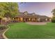 Two-story home with brick facade, three-car garage, and a circular driveway at 1409 E Dove Pl, Casa Grande, AZ 85122