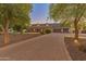 Grand home exterior with long driveway and mature trees at 1409 E Dove Pl, Casa Grande, AZ 85122