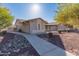 Side view of a single-story home showcasing a walkway and rock landscaping at 1745 E Palm Parke Blvd, Casa Grande, AZ 85122