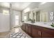 Double vanity bathroom with large mirror and walk-in shower at 1907 W Brooke Ln, Queen Creek, AZ 85144