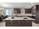 Modern kitchen featuring a large island and dark cabinetry at 1907 W Brooke Ln, Queen Creek, AZ 85144