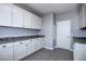 Bright laundry room with white cabinets and grey countertop at 1907 W Brooke Ln, Queen Creek, AZ 85144