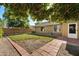 Spacious backyard with grassy area, patio, and mature trees at 1964 W Sawtooth Way, San Tan Valley, AZ 85144