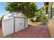 Landscaped backyard with storage shed and patio area at 1964 W Sawtooth Way, San Tan Valley, AZ 85144