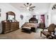 Main bedroom with large dresser, comfortable bed, and ceiling fan at 1964 W Sawtooth Way, San Tan Valley, AZ 85144