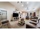 Bright living room featuring ample seating and a large TV at 1964 W Sawtooth Way, San Tan Valley, AZ 85144