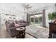 Bright living room with grey sectional sofa, large window and view to backyard at 3264 N 195Th Dr, Buckeye, AZ 85396