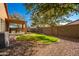 Backyard with covered patio and grassy area at 45759 W Morning View Ln, Maricopa, AZ 85139