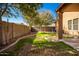 Backyard with grassy area, gravel, and block wall at 45759 W Morning View Ln, Maricopa, AZ 85139