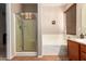 Clean bathroom featuring a shower and bathtub at 45759 W Morning View Ln, Maricopa, AZ 85139