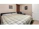 Cozy bedroom with a plaid comforter and plenty of room at 45759 W Morning View Ln, Maricopa, AZ 85139