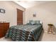 Serene bedroom with a stylish bedspread and a small stool at 45759 W Morning View Ln, Maricopa, AZ 85139