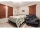 Bright bedroom with a relaxing atmosphere and a comfortable armchair at 45759 W Morning View Ln, Maricopa, AZ 85139
