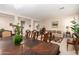 Elegant dining room with chandelier and view into the living room at 45759 W Morning View Ln, Maricopa, AZ 85139