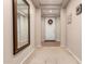 Bright entryway with tile floors, a mirror, and a wreath on the door at 45759 W Morning View Ln, Maricopa, AZ 85139