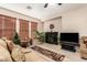 Living room featuring a fireplace, large windows, and comfy seating at 45759 W Morning View Ln, Maricopa, AZ 85139