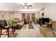 Spacious living room with a cozy seating area and a large TV at 45759 W Morning View Ln, Maricopa, AZ 85139