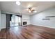 Living room with fireplace, wood floors, and sliding door at 4715 N 64Th Ave, Phoenix, AZ 85033