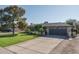 Single-story home with a two-car garage and well-manicured lawn at 5213 W Sweetwater Ave, Glendale, AZ 85304