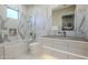 Contemporary bathroom with marble tile, a bathtub, and modern fixtures at 6816 E Stagecoach Pass Pass, Carefree, AZ 85377