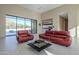 Open living area with red leather couches and view of pool at 6816 E Stagecoach Pass Pass, Carefree, AZ 85377