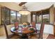 Formal dining room with round table, wood chairs, and mountain views at 8128 E Greythorn Dr, Gold Canyon, AZ 85118