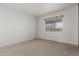 Bedroom with neutral walls and carpeting, featuring a window at 8140 E Cactus Dr, Mesa, AZ 85208