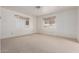 Bright bedroom with neutral carpeting and ample natural light at 8140 E Cactus Dr, Mesa, AZ 85208