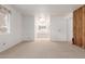 Bedroom with neutral carpeting and view into the bathroom at 8140 E Cactus Dr, Mesa, AZ 85208