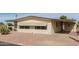 Front view of a beige manufactured home with a covered carport and gravel landscaping at 8140 E Cactus Dr, Mesa, AZ 85208