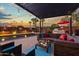 Stunning pool and patio area with pergola, seating, and sunset view at 8450 E Montecito Ave, Scottsdale, AZ 85251