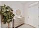 Bright and airy entryway with decorative console table and large plant at 8653 E Royal Palm Rd # 2019, Scottsdale, AZ 85258