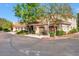 Tan stucco building with attached garages and landscaping at 8653 E Royal Palm Rd # 2019, Scottsdale, AZ 85258