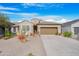 Single-story home with desert landscaping and a two-car garage at 9788 E Hay Loft Dr, Florence, AZ 85132